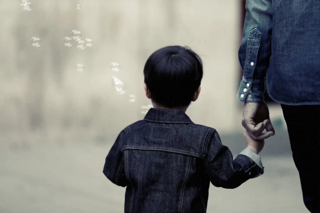 kid holding parent hand